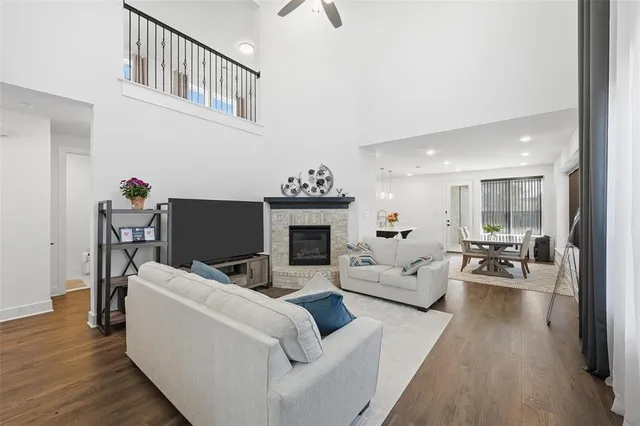 a living room with furniture a fireplace and wooden floor
