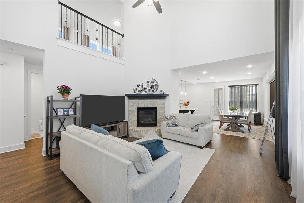 2416 Gallions Road Celina, TX 75009 - Photo 3 of 33 a living room with furniture a fireplace and wooden floor