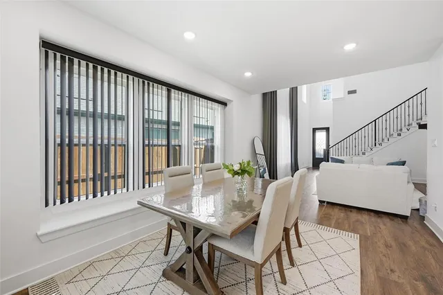 a dining room with furniture and wooden floor
