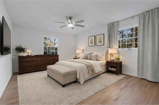 a spacious bedroom with a bed and a chandelier