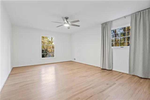 wooden floor in an empty room with a window