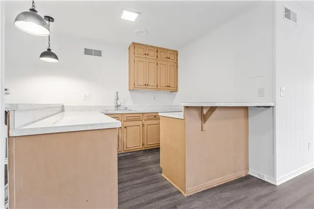 a utility room with cabinets washer and dryer