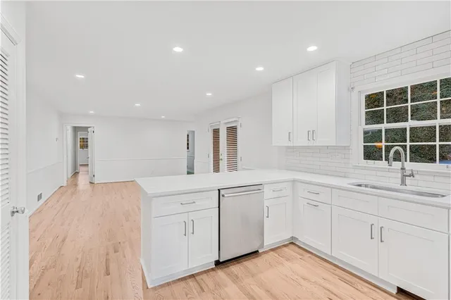 a kitchen with a sink stove and cabinets