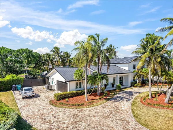 a view of a house with swimming pool and sitting area