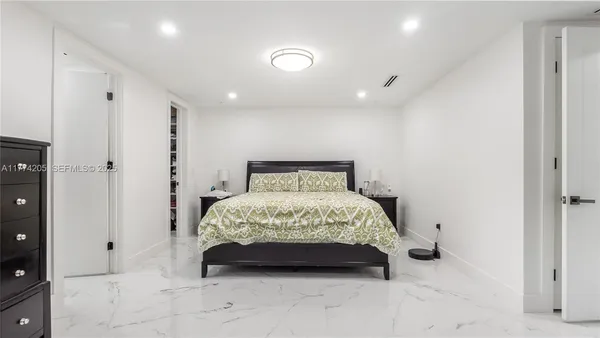 a bathroom with a granite countertop sink a toilet and shower