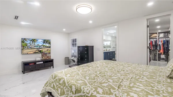 a bathroom with a double vanity sink toilet and shower