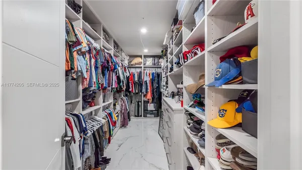 a bedroom with a bed and a refrigerator
