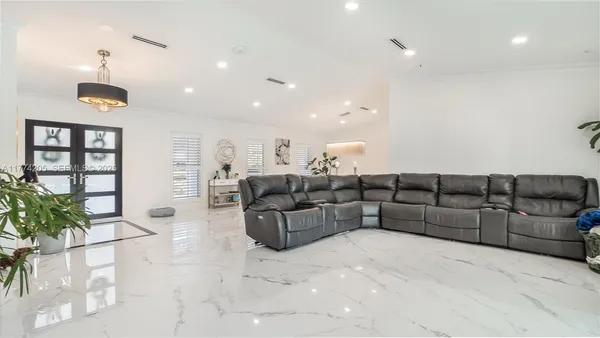 a dining room with furniture and a floor to ceiling window