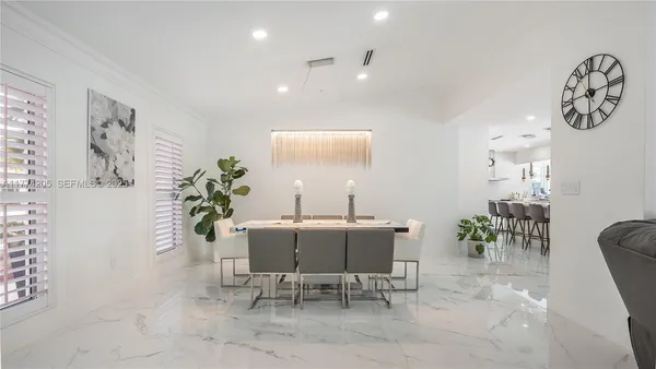 a kitchen with stainless steel appliances kitchen island granite countertop a sink and cabinets