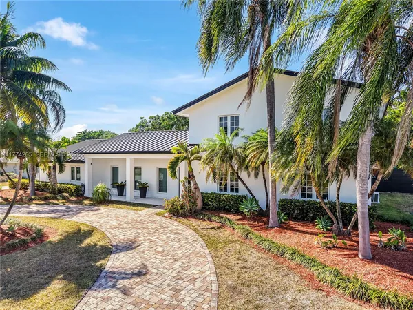a view of a palm trees in front of a house