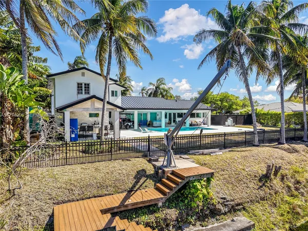 a view of a house with a yard and table under an umbrella
