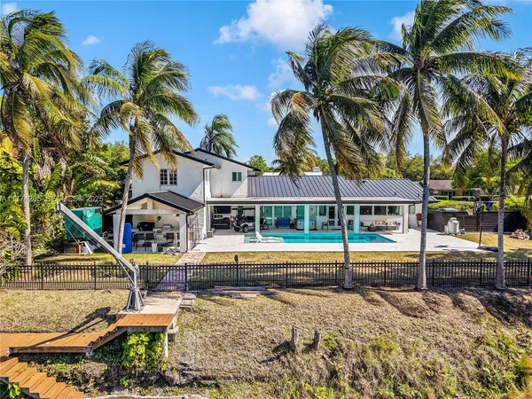 an aerial view of a house with yard swimming pool and outdoor seating