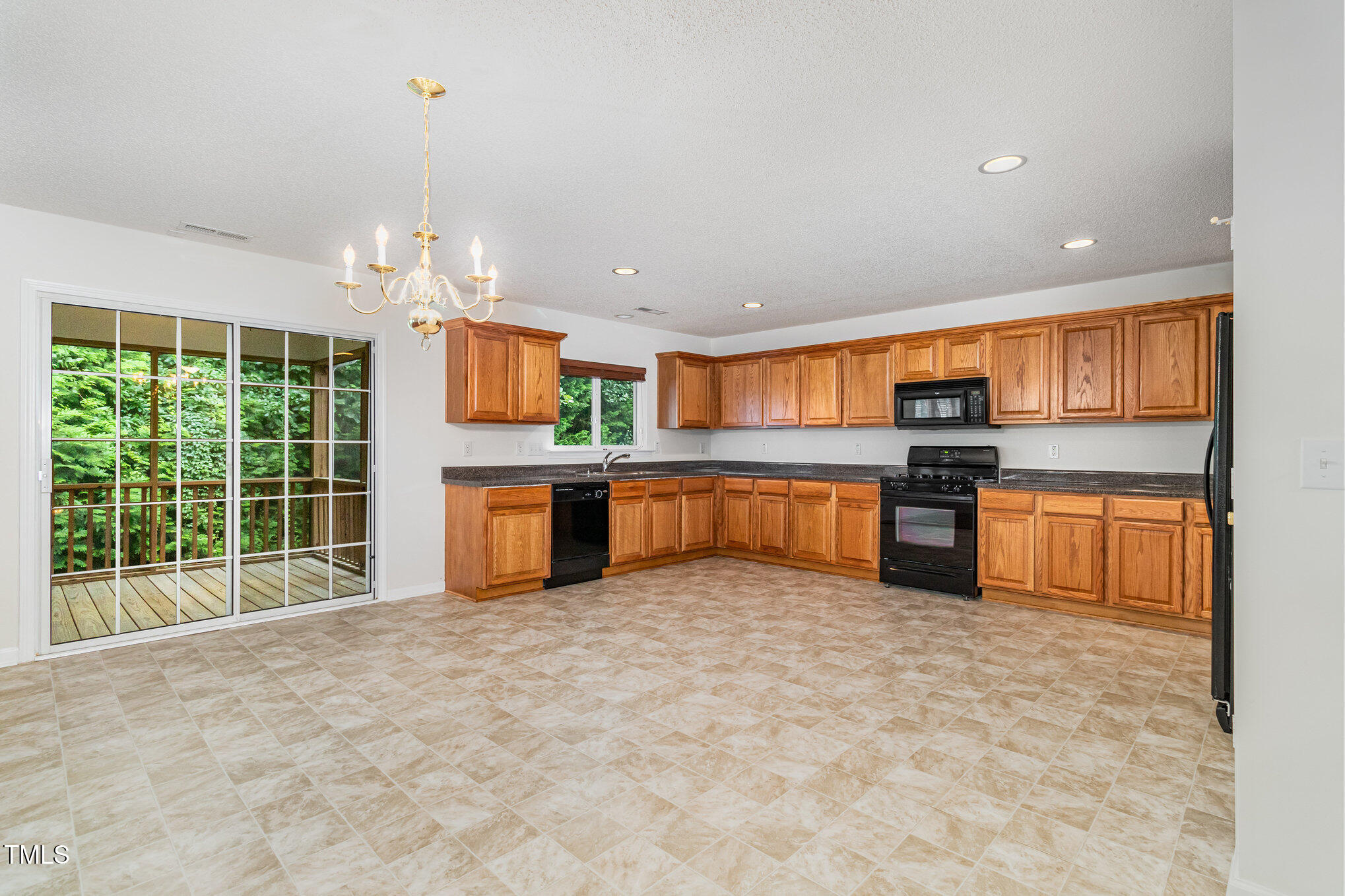 5404 Meryton Park Way Raleigh, NC 27616 - Photo 13 of 35 a large kitchen with stainless steel appliances granite countertop a stove and a sink