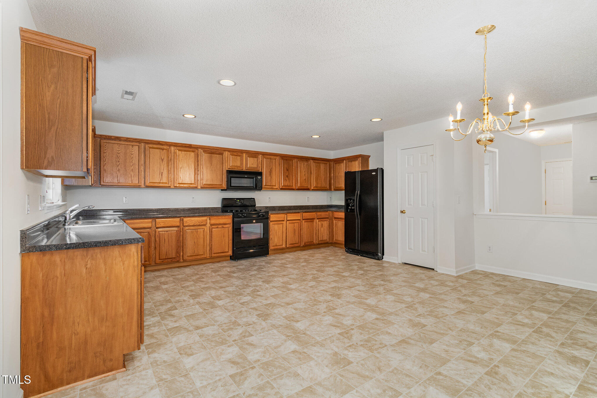 5404 Meryton Park Way Raleigh, NC 27616 - Photo 14 of 35 a kitchen with stainless steel appliances granite countertop a sink and cabinets