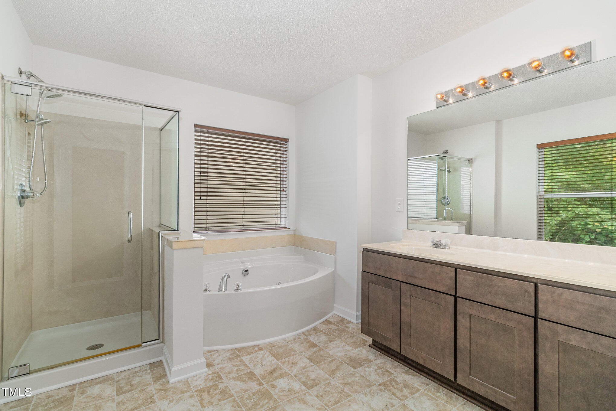 5404 Meryton Park Way Raleigh, NC 27616 - Photo 22 of 35 a bathroom with a tub sink shower and mirror