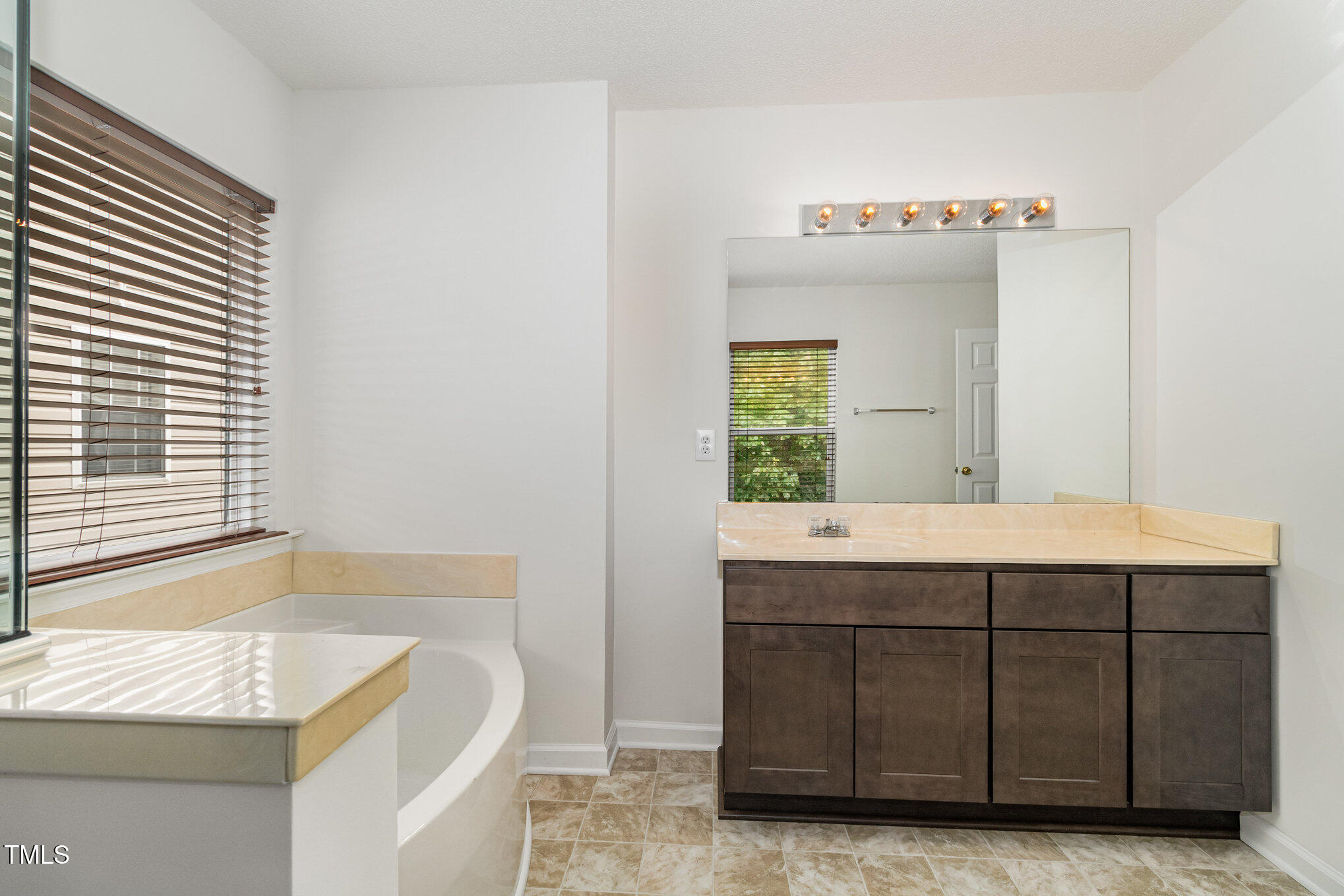 5404 Meryton Park Way Raleigh, NC 27616 - Photo 23 of 35 a bathroom with a sink and a bathtub