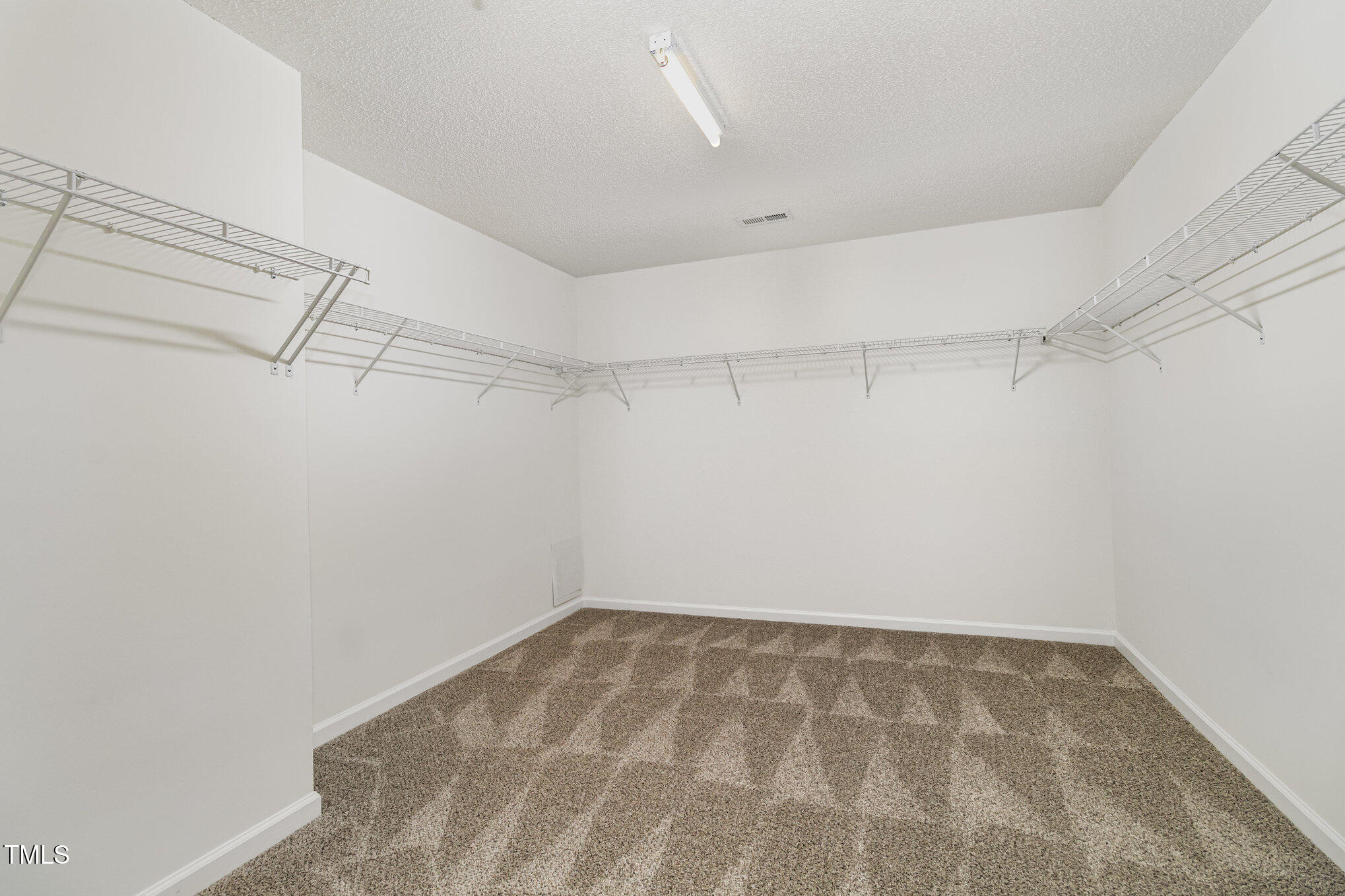 5404 Meryton Park Way Raleigh, NC 27616 - Photo 24 of 35 a view of a room with racks on the wall