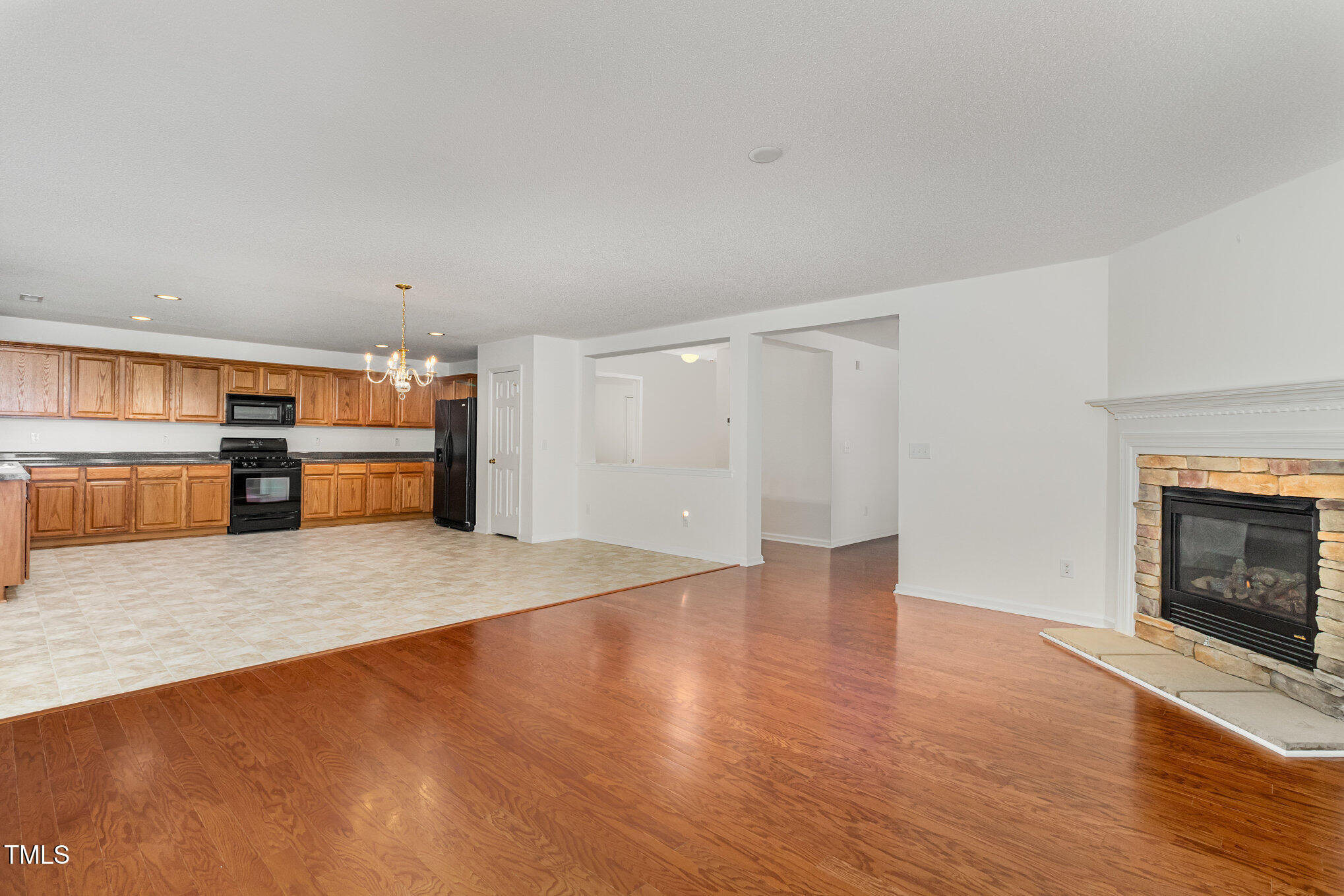 5404 Meryton Park Way Raleigh, NC 27616 - Photo 10 of 35 a view of a kitchen with a sink stove cabinets and empty room