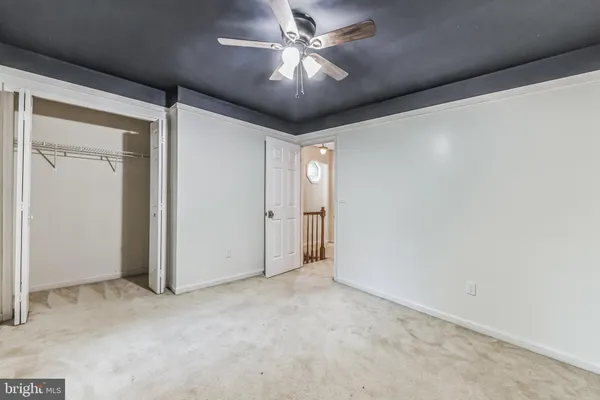 a view of a chandelier fan and closet in a room