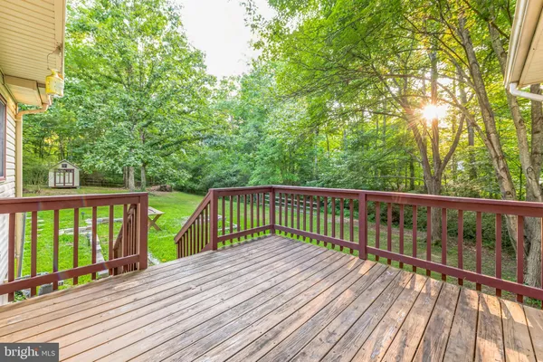 a view of balcony with wooden floor and fence