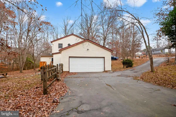 a view of a house with a yard and garage