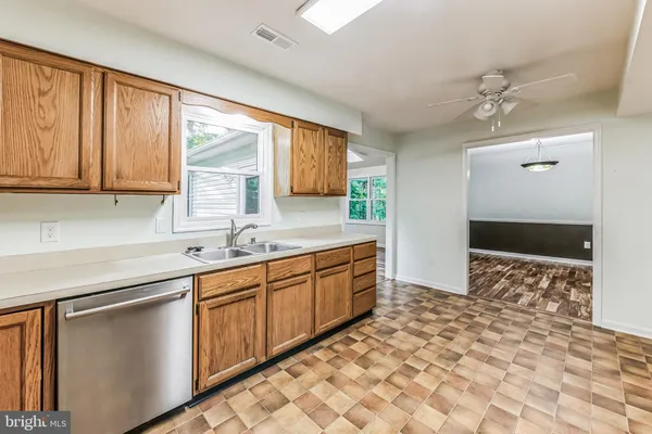a kitchen with stainless steel appliances granite countertop a sink and a cabinets