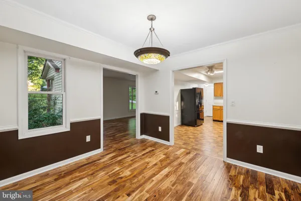 a view of a room with wooden floor and windows