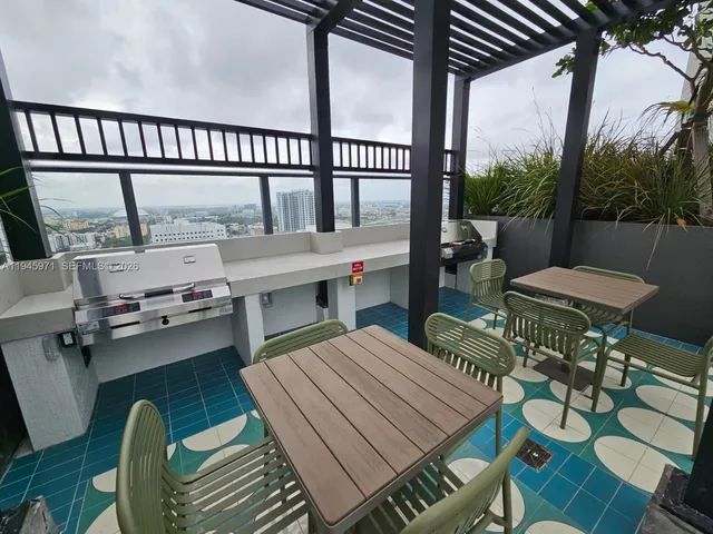 a view of a dining room with furniture a chandelier and wooden floor