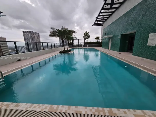 a outdoor space with patio the couches and a dining table with the view of swimming pool