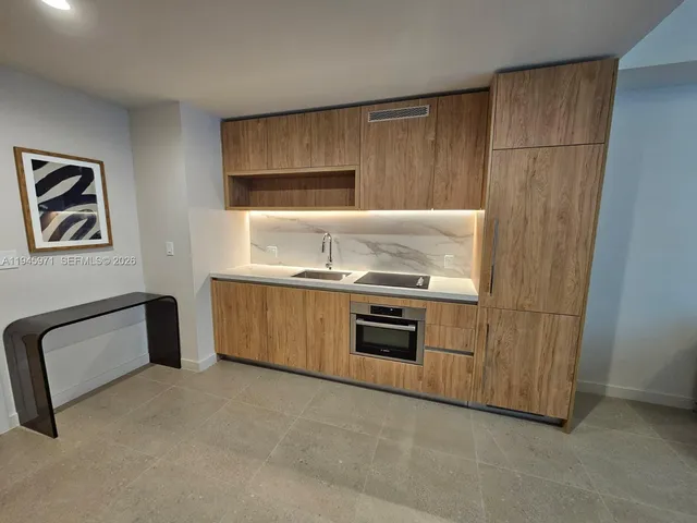 a kitchen with a stove and a refrigerator