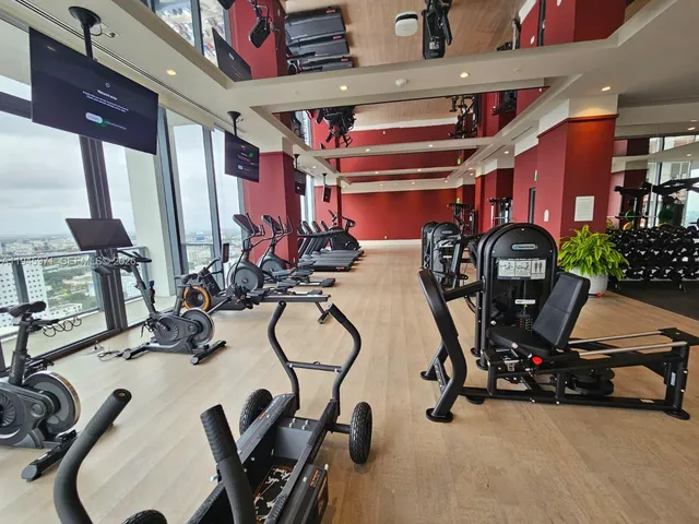 a kitchen with a stove a sink a window and wooden floor