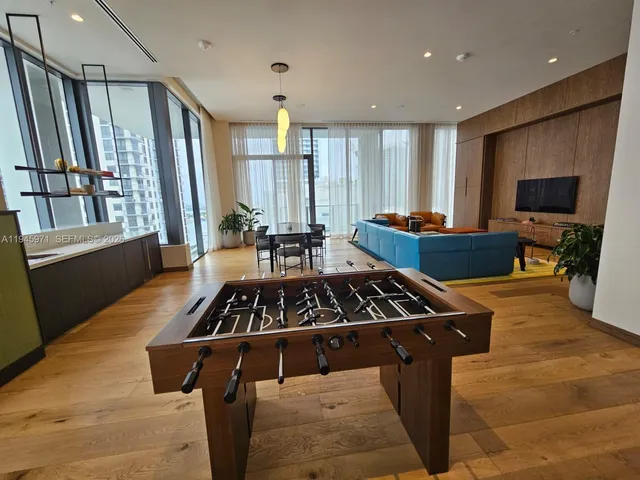 a projector room with chairs and a flat screen tv