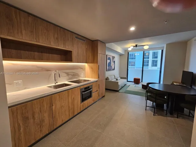 a living room with furniture a lamp and a large window