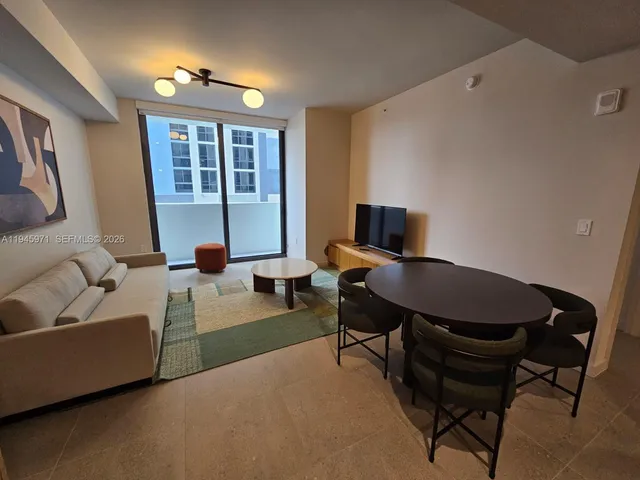 a living room with couches and painting on the wall