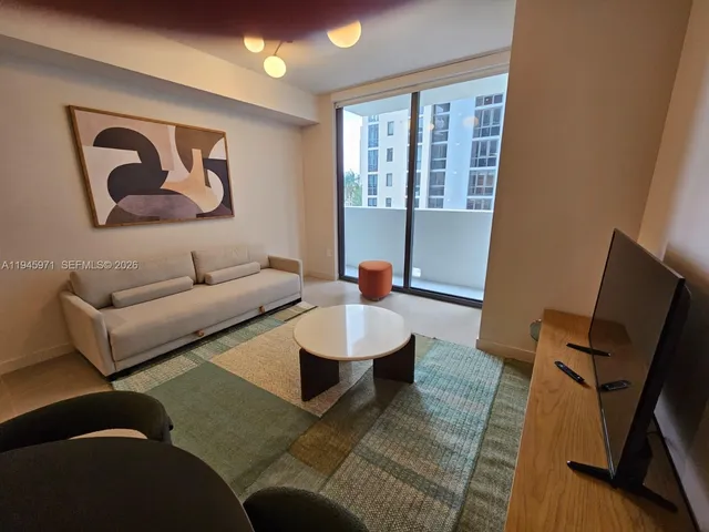 a living room with furniture a wooden floor and a table