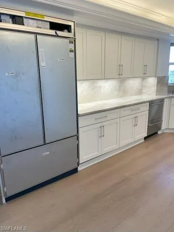a white refrigerator freezer sitting in a kitchen