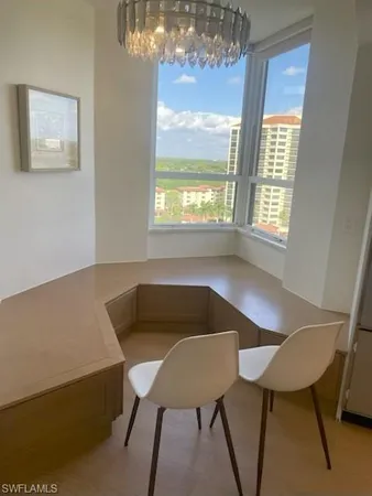 a view of a dining room with furniture and window