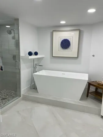a bathroom with a bathtub and a shower