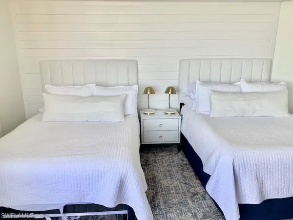 a bed room with a bed and a chair