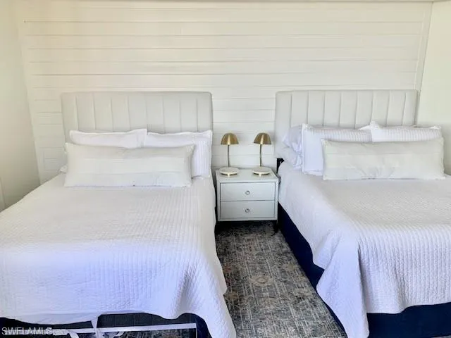 a bed room with a bed and a chair