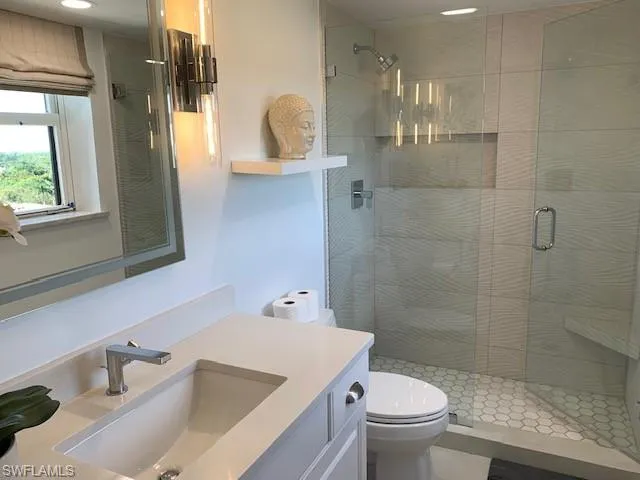 a bathroom with a sink toilet and shower