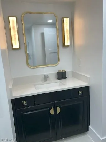 a bathroom with a sink and two mirror