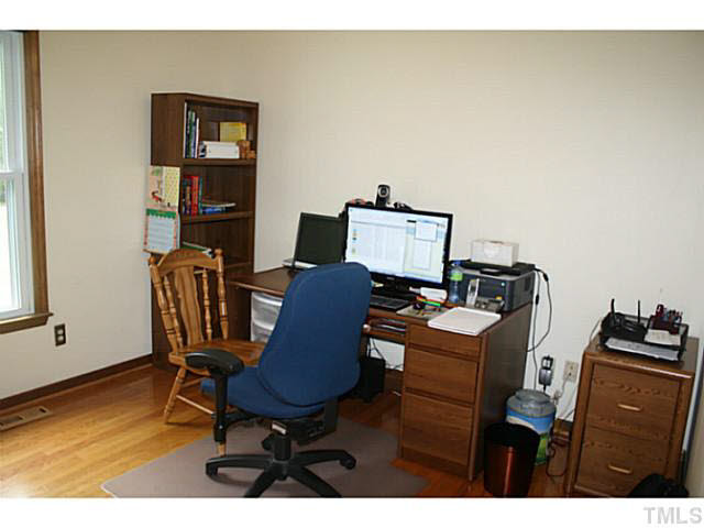 2000 Canterbury Road Clayton, NC 27520 - Photo 17 of 25 This bedroom is currently being used as an office, and features a double door closet, a ceiling fan with light kit, and lovely hardwood floors. Bedroom