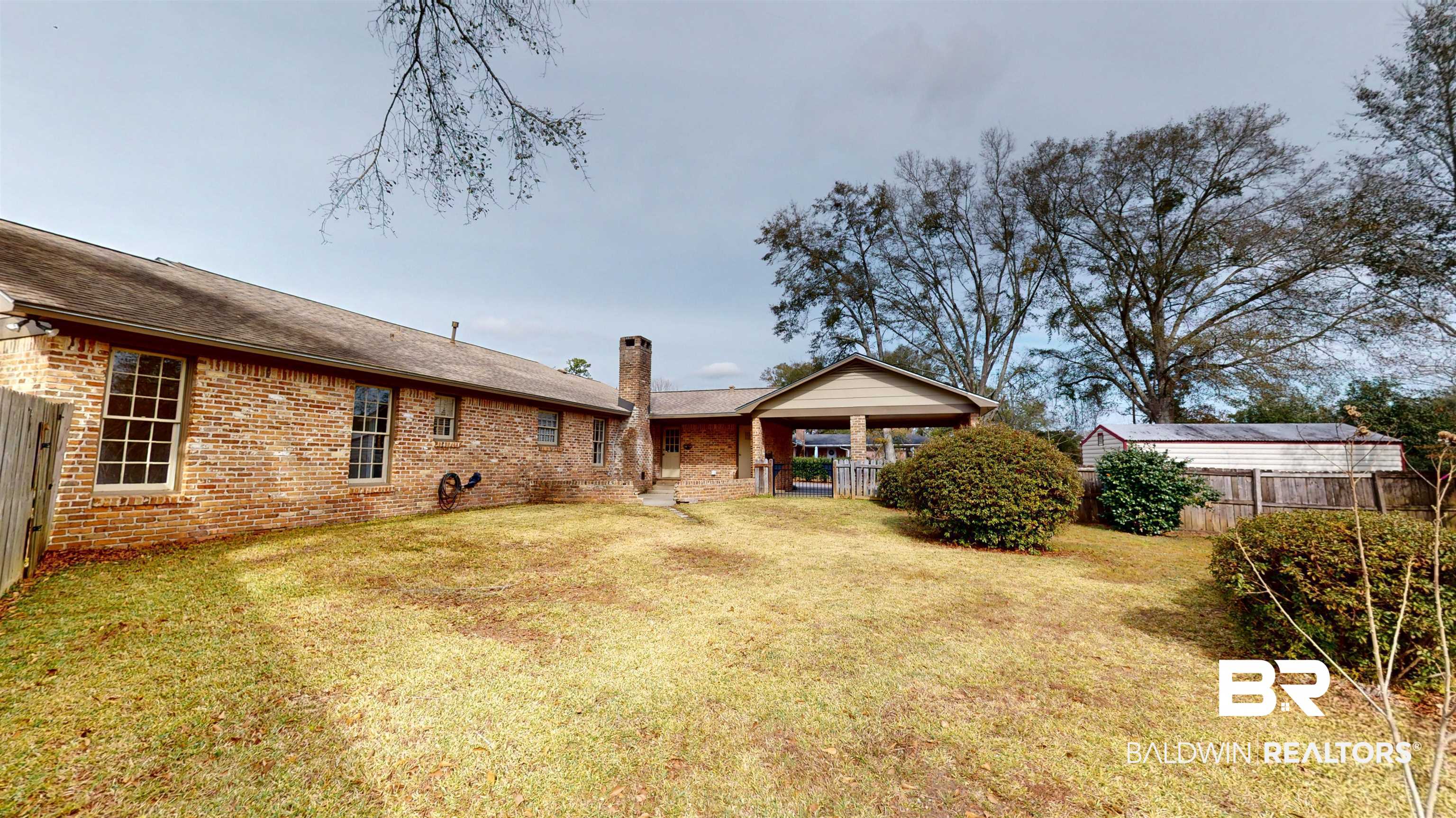 609 Burlington Court Mobile, AL 36608 - Photo 18 of 19 Rear view of property with brick siding, a shingled roof, and a chimney