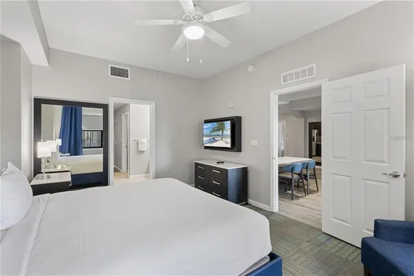 a bedroom with a large bed and chandelier