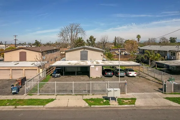 an aerial view of residential houses with yard