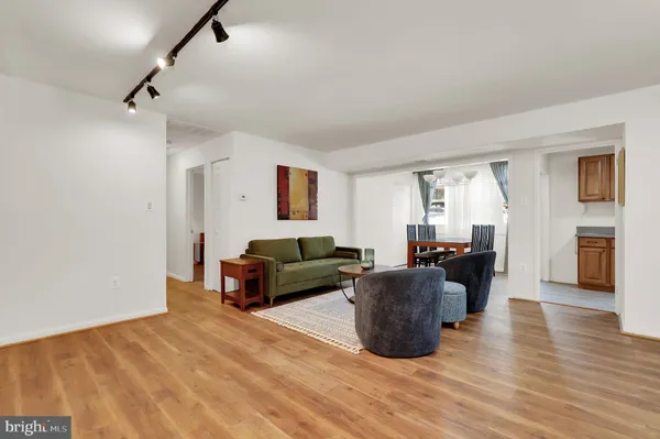 a living room with furniture a ceiling fan and a rug
