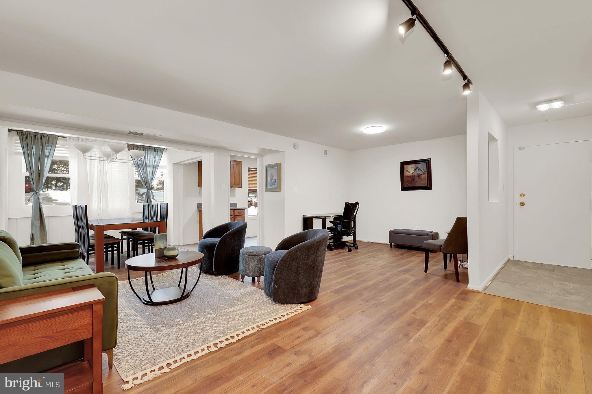 9645 White Acre Road, Unit A2 Columbia, MD 21045 - Photo 4 of 25 a living room with furniture and a wooden floor