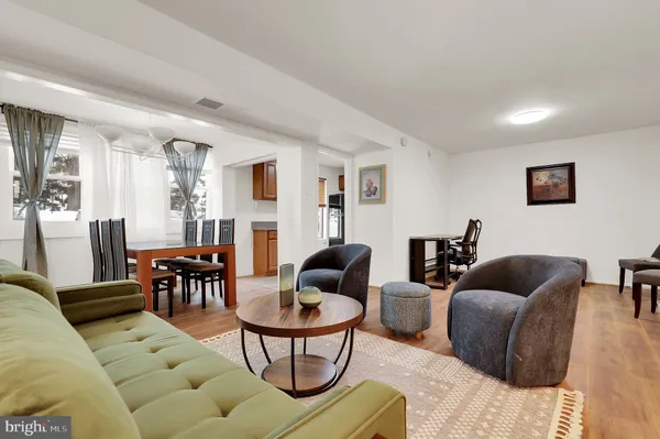 a living room with furniture or couch and a dining table
