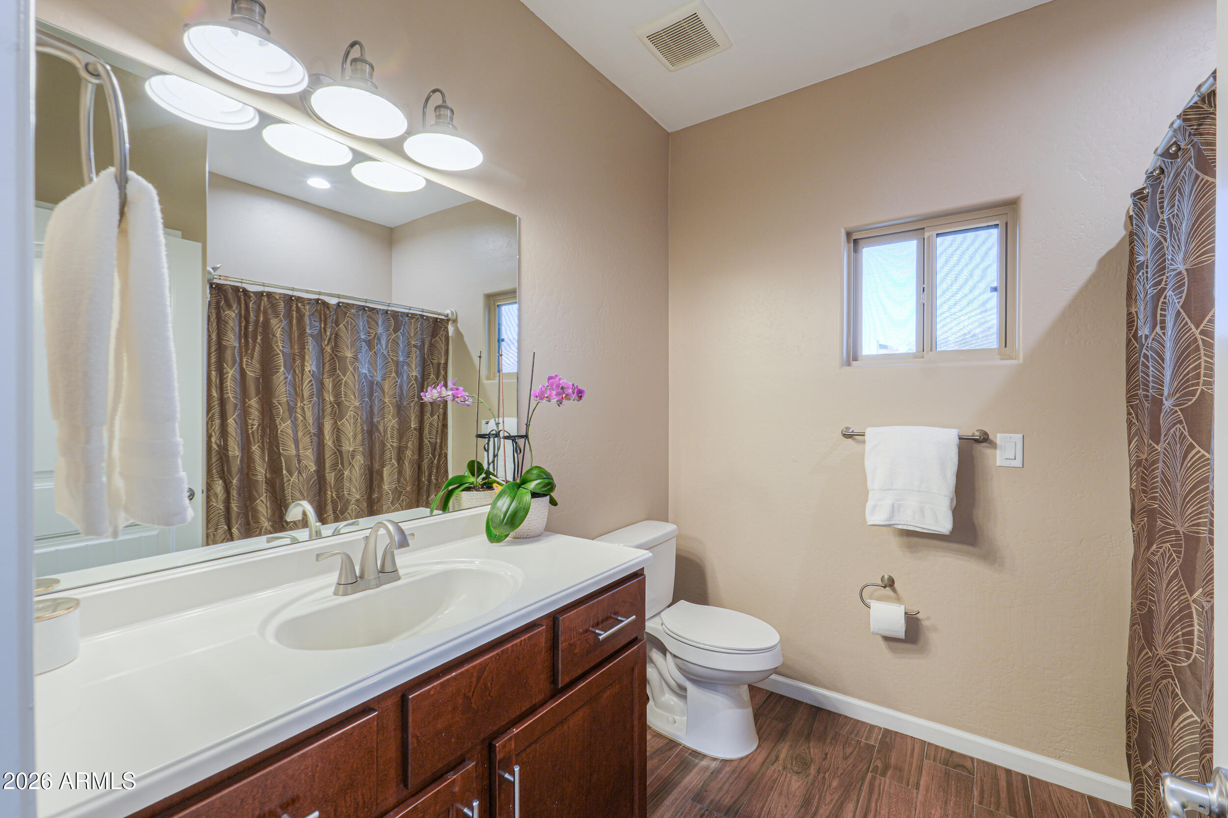1487 South Mountain View Road Apache Junction, AZ 85119 - Photo 24 of 60 a bathroom with a toilet sink and mirror